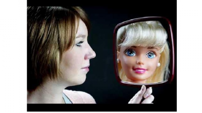 This is a picture of a women looking at fake version of herself.